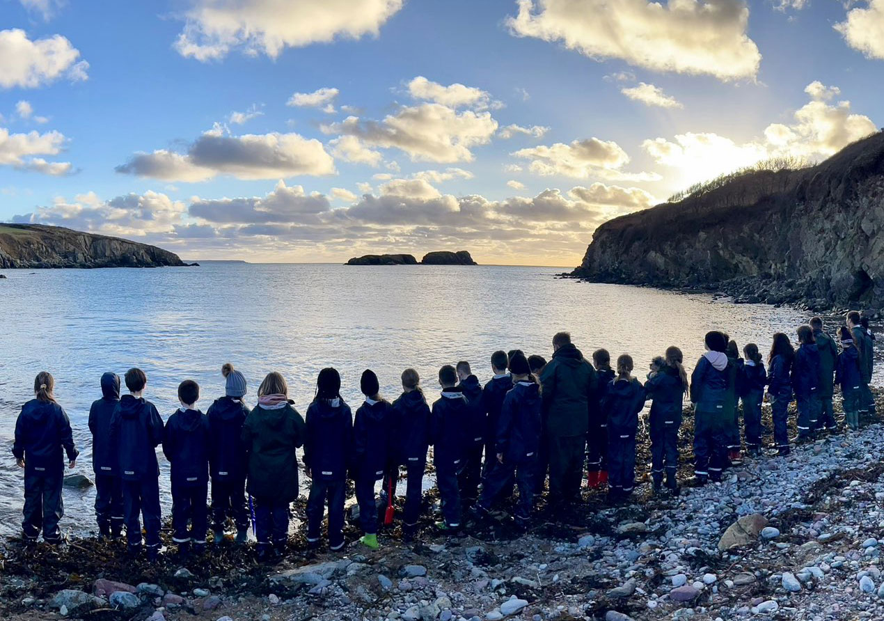 Group of children from Farms for City Children looking out to sea