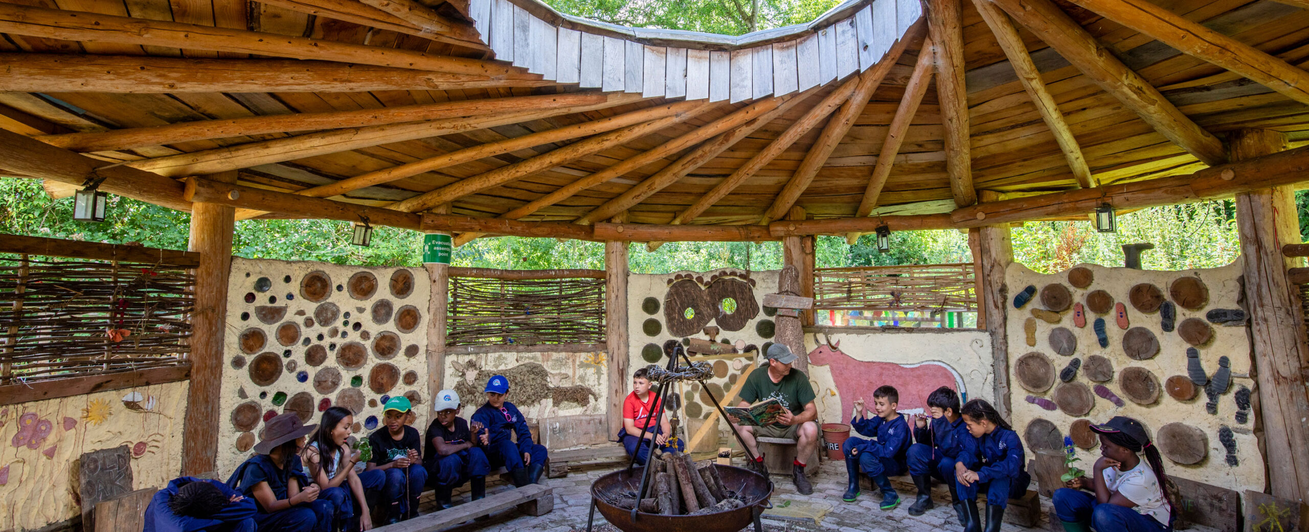 Children participating in a storytelling session in the Wick Court farm roundhouse